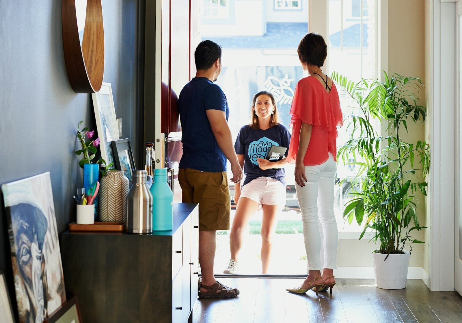 2 women standing beside man in blue t-shirt